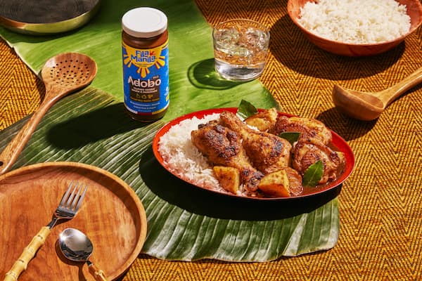 Fila Manila's Adobo Sauce with rice and chicken on a plate.